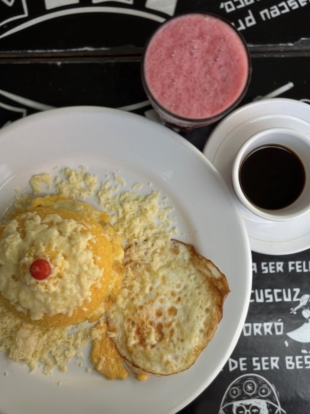 The cuscuz served with juice and coffee on the house table.