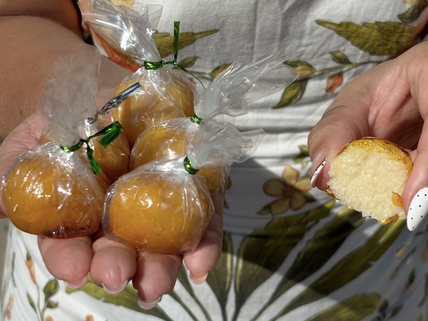 Wrapped balas baianas in the seller’s hand, and one cut in half