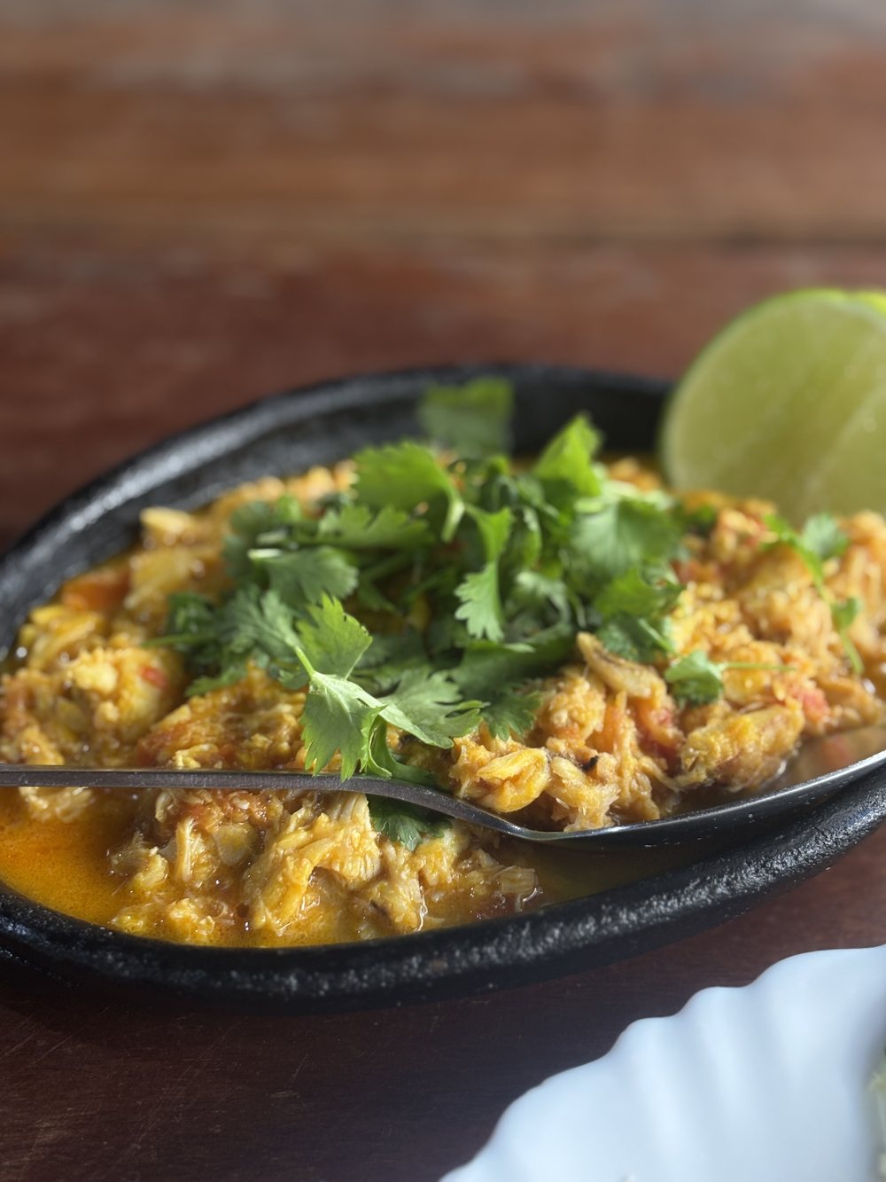 Picked crab in the iron pan, with coriander and lime.