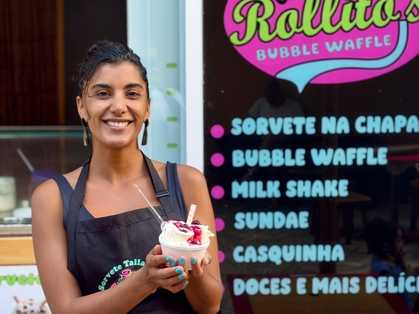 Bianca at the door of Rollito's, holding an ice cream.